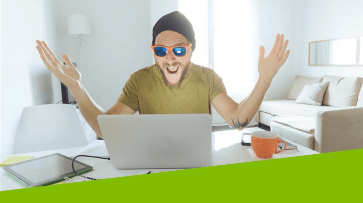 Happy man front of his laptop